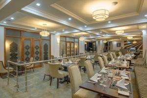 a dining room with long tables and chairs at GemSuites Riverside Serviced Apartments and Hotel, Nairobi in Nairobi