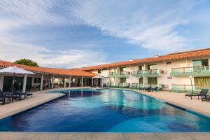 a swimming pool in front of a hotel at Arrey Hotel Beach in Parnaíba