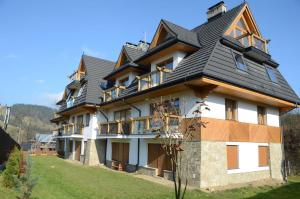 a large house with a gambrel roof at 4U Apartments - Zakopane in Zakopane