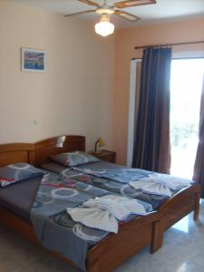 a bedroom with a large bed with towels on it at Gouna's Aparts in Xi