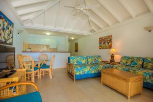 a living room with a couch and a table at Shoal Bay Villas in Shoal Bay Village