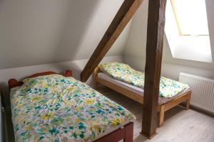 a bedroom with two bunk beds and a window at Mazurskie Apartamenty in Pasym