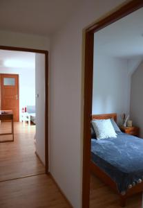 a bedroom with a bed and a door leading into a room at Apartament sopot 2 pokoje in Sopot