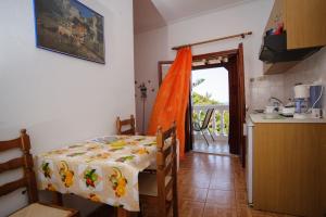 a kitchen with a table with a table cloth on it at Athina Studios in Ágios Dimítrios