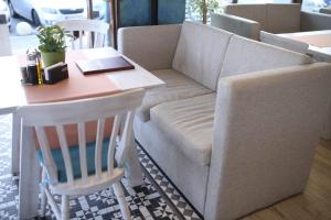 a living room with a table, chairs and a coffee table at Hotel Agapi Mamaia in Mamaia