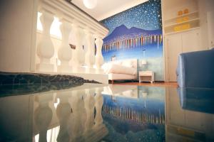 a bedroom with a bed and a reflection in the floor at NapoliMia Boutique Hotel in Naples