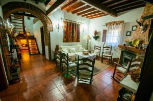 a living room with a table and chairs in it at Casa Rural Finca Umbría in Plasencia