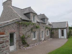 an old stone house with a driveway at Au Clair de la Dune in Frehel