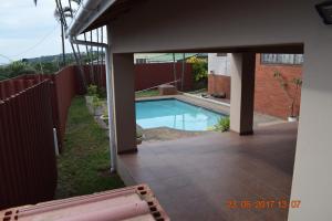 a swimming pool in the backyard of a house at Clycherco Self Catering in Durban