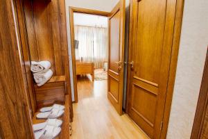 a hallway with a room with a door and towels at Mini-Hotel Sultan in Astana