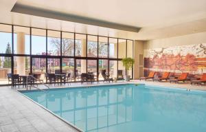 a pool in a hotel with tables and chairs at Hyatt Regency Lexington in Lexington