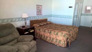 a hotel room with a bed and a couch at White Valley Motel in Saint Charles