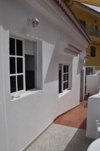 a white house with windows and a patio at Casa Mussa in Valle Gran Rey +21 photos