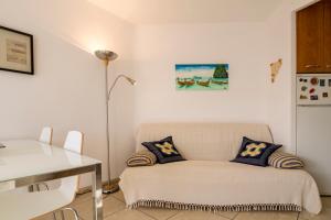 a room with a couch and a table and a lamp at Calafell Apartment 4 in Calafell