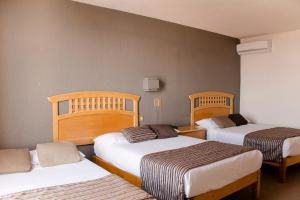 Postel nebo postele na pokoji v ubytování Hotel El Monte