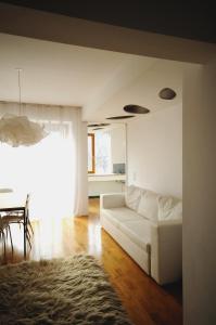 a living room with a white couch and a table at Architectural City Loft in Sofia