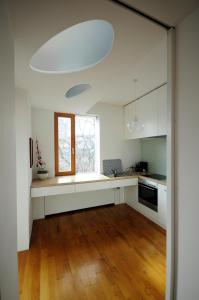 a kitchen with white cabinets and a window at Architectural City Loft in Sofia