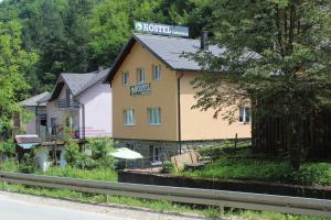 een geel gebouw met een bord erop bij Hostel Srebrenica in Srebrenica