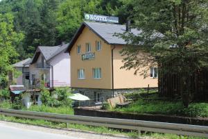 a yellow building with a sign on top of it at Hostel Srebrenica in Srebrenica