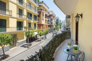 a balcony with a table and chairs and buildings at Art de vivre in Sorrento
