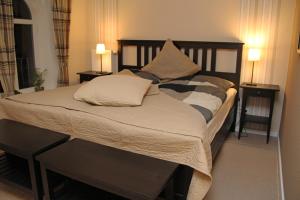 a bed with two pillows on it in a room at Station L in Langballig