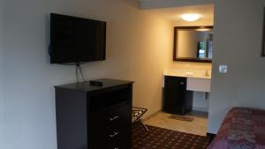 a hotel room with a television on the wall at Best Stay Inn in Plainville