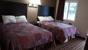 a hotel room with two beds and a window at Best Stay Inn in Plainville