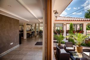 an open lobby with chairs and tables on a patio at Corvin Pension and Restaurant in Veľký Meder