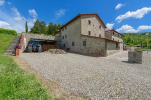 a large stone building with two bikes parked in front of it at Agriturismo Casapasserini in Londa
