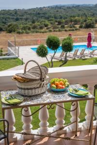 a table with a basket of fruit on a balcony at Elaias Gi Residence in Mousata