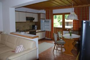 a kitchen with a couch and a table in a kitchen at Rosumerhof in Leutasch