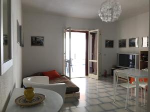 a living room with a couch and a table at Casa Paloma in Letojanni