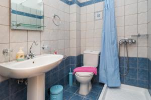 a bathroom with a sink and a toilet and a shower at Elaias Gi Residence in Mousata +34 photos