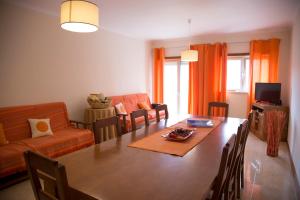 a living room with a dining room table and a couch at Your HOME, Nazaré in Nazaré