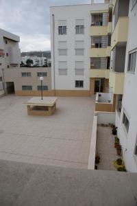 a large courtyard with a bench in the middle of a building at Your HOME, Nazaré in Nazaré