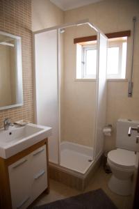 a bathroom with a shower and a toilet and a sink at Your HOME, Nazaré in Nazaré