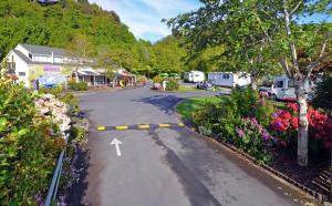 a street filled with lots of green and yellow flowers at Leith Valley Holiday Park and Motels in Dunedin
