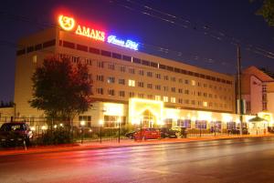 a building with a sign on top of it at night at AMAKS Premier Hotel in Perm
