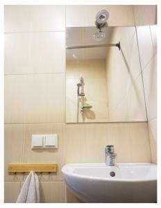 a bathroom with a sink and a mirror at Looming Hostel in Tartu