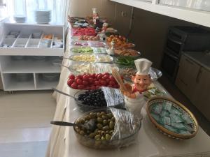 a long buffet of food on a table in a kitchen at Konyaaltı HOTEL in Antalya