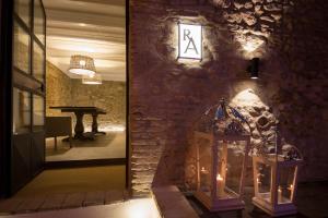 a room with a stone wall with two candles and a table at Residenza Amblingh in Vasto