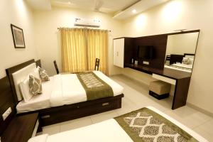 
a hotel room with a bed and a television at Hotel Fortune Plaza in Ajmer
