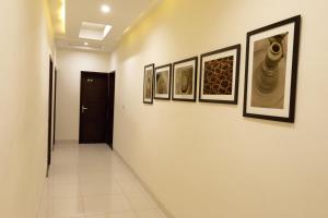 
a room with a painting on the wall and a picture on the wall at Hotel Fortune Plaza in Ajmer
