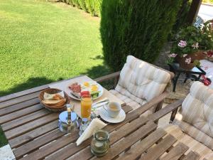 a picnic table with breakfast foods and drinks on it at Guest House Balchik Hills in Balchik