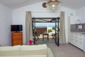 a living room with a couch and a table and a television at Casa Berriel 1 in Tías