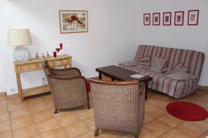 a living room with a couch and a table and chairs at Ferme Saint Christophe in Saint-Marcan