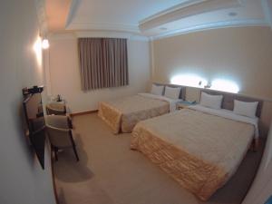 Postel nebo postele na pokoji v ubytování ChangSing Business Motel