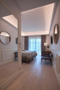 a bedroom with a bed and a large mirror at Hotel Majestic in Budva