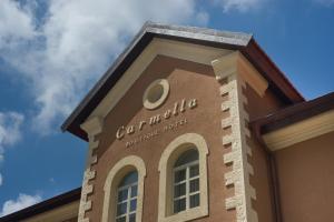 a building with a sign on the side of it at Carmella Spa & Boutique Hotel in Haifa