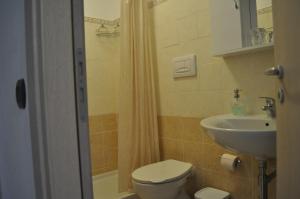 a bathroom with a toilet and a sink at Santa Maria in Cittadella del Capo +20 photos